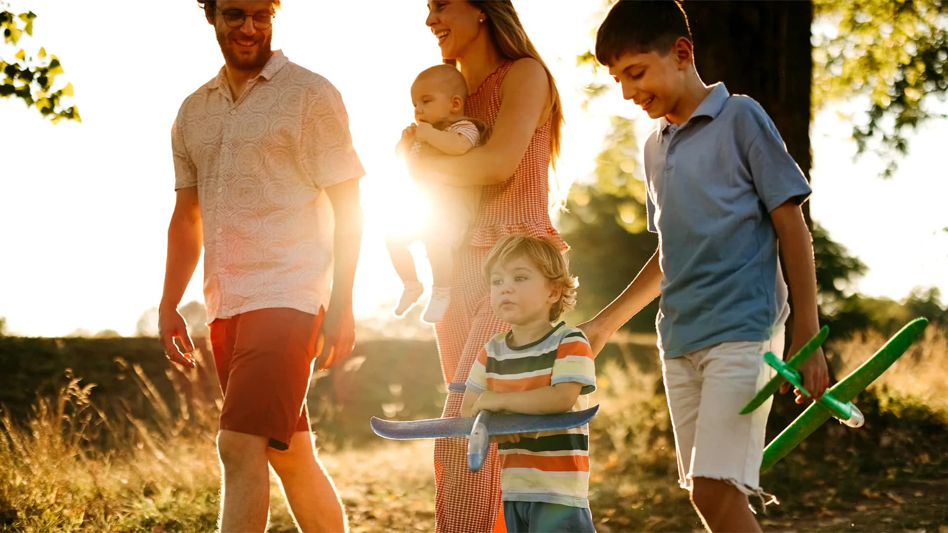 Lifestyle photograph from the Bolton Place marketing set — a family walking at golden hour near Bolton, Caledon. Not an architectural rendering of the community.