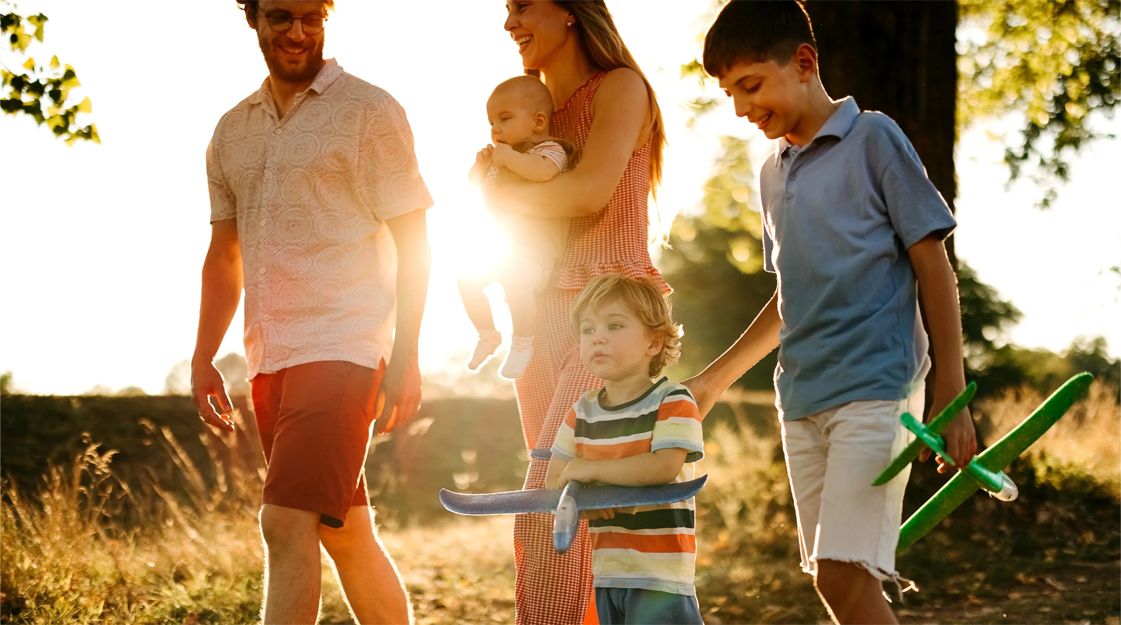Lifestyle photograph labelled caledon-station in the Bolton Place marketing set — a family walking outdoors near Bolton, Caledon. Not a rendering of a GO station or the community.